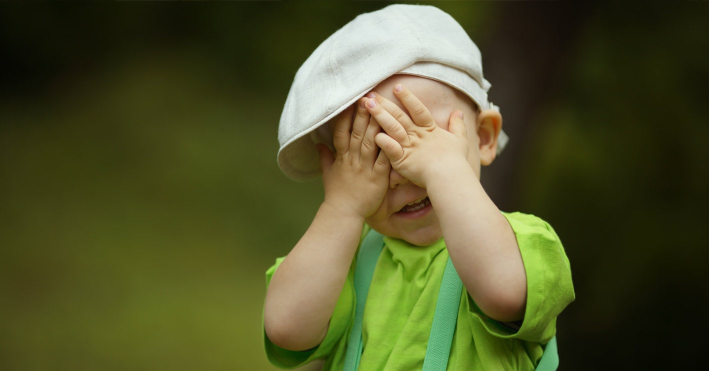 boy covering his eyes