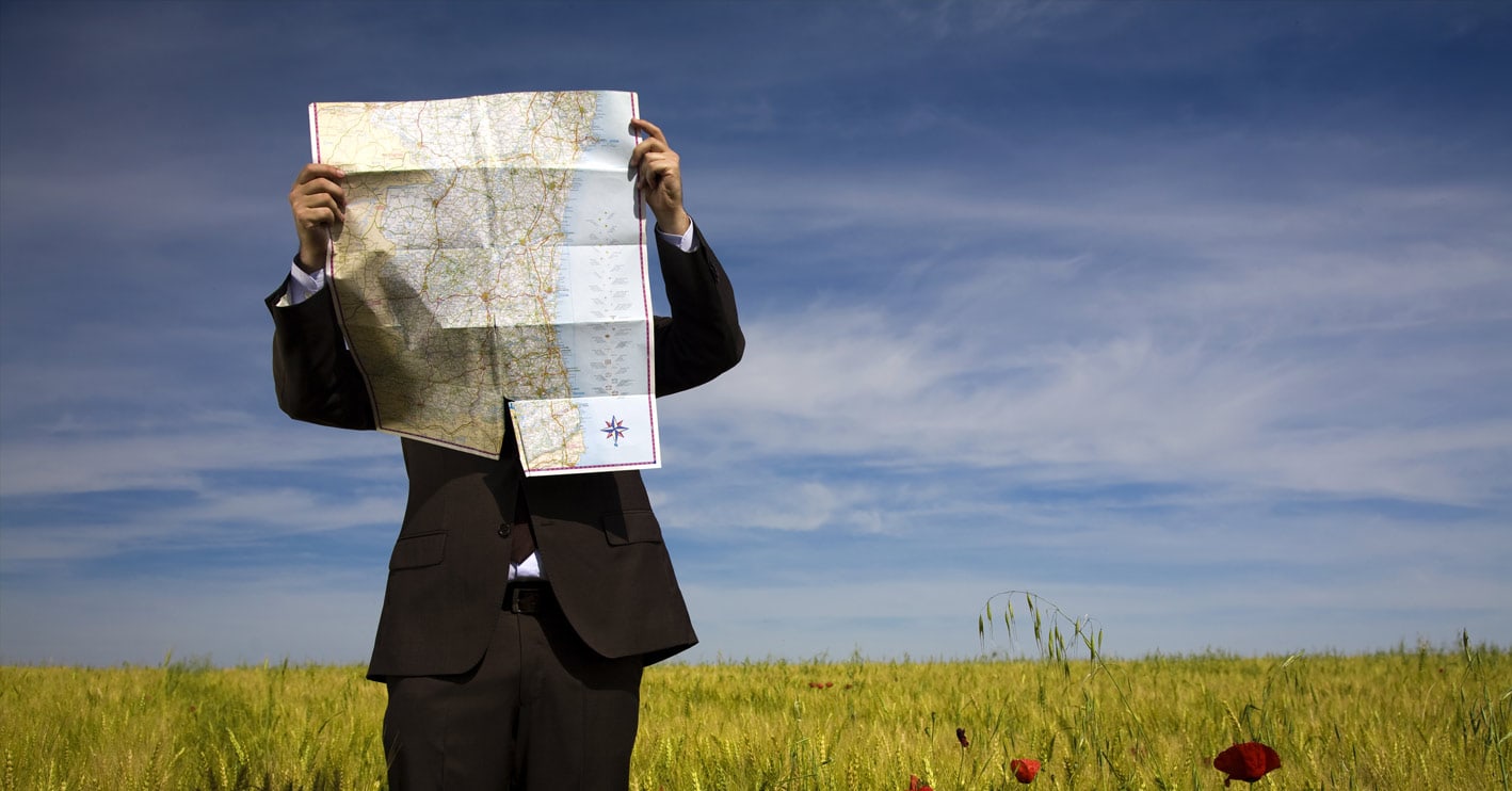 man covering his face with a map