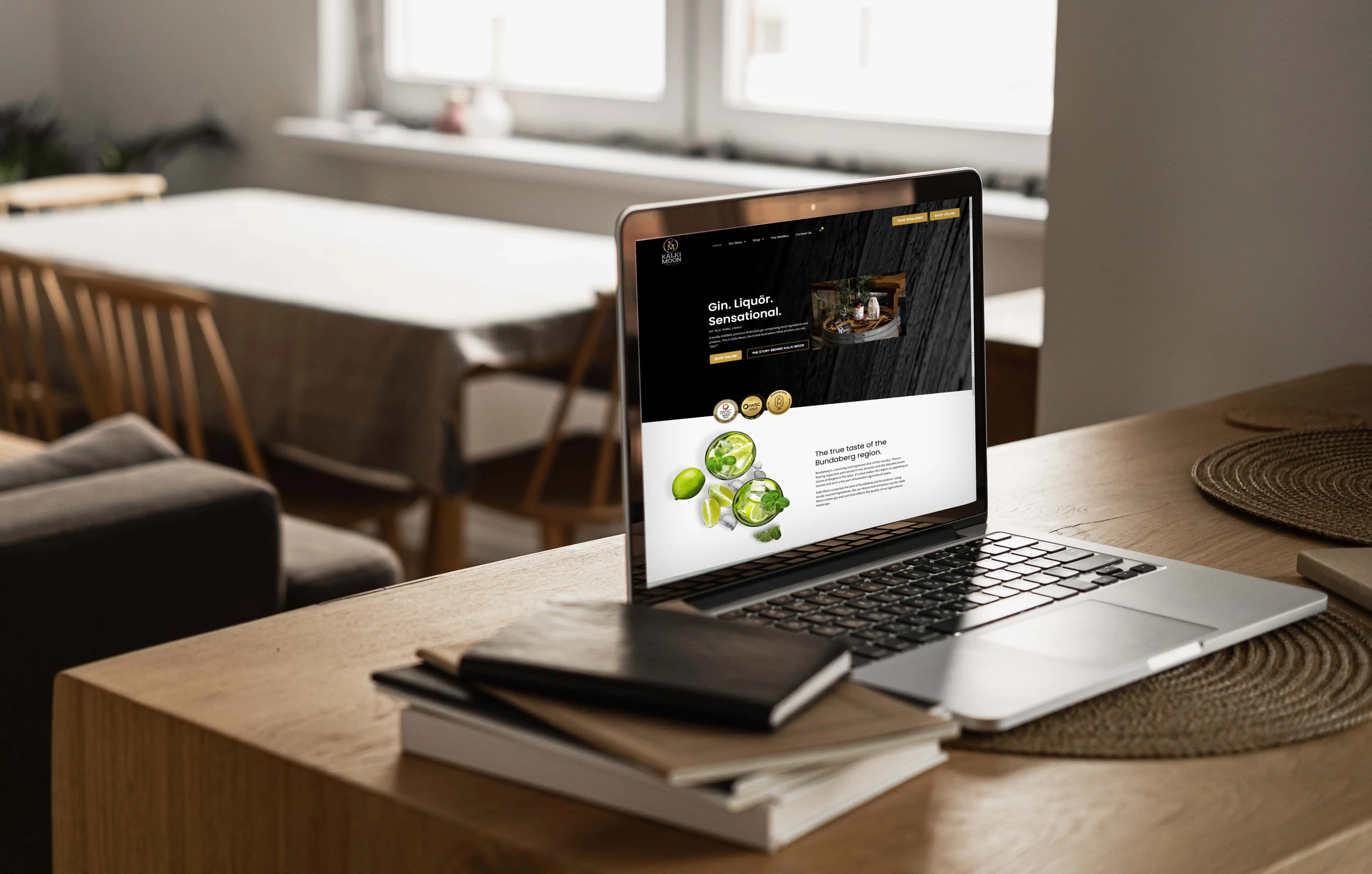 Laptop computer with blank screen, notebooks on wooden table in