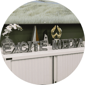 Excite Media spelled out in silver metal letters