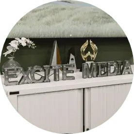 Excite Media spelled out in silver metal letters