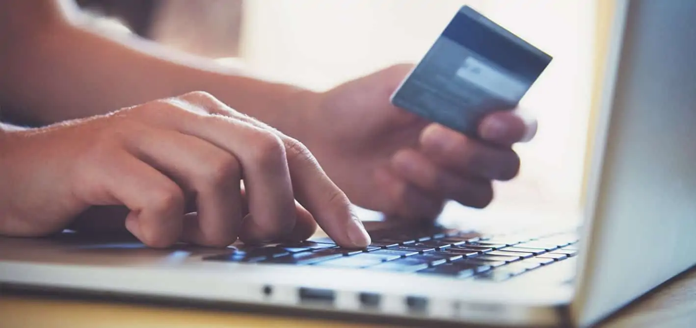 an image of an online shopper with credit card in hand