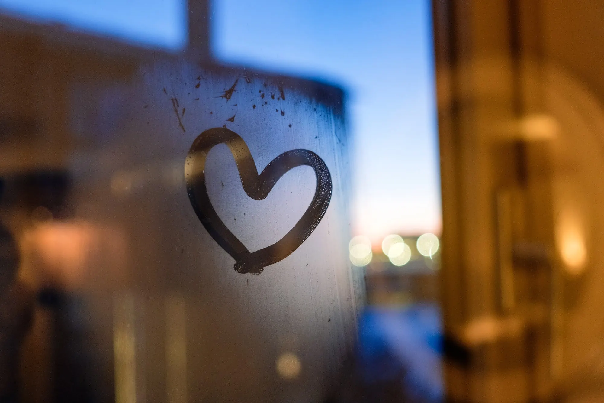 Drawing heart on window in winter