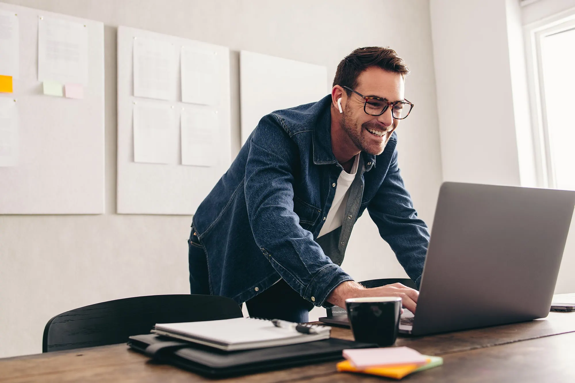 Happy businessman connecting with his team online