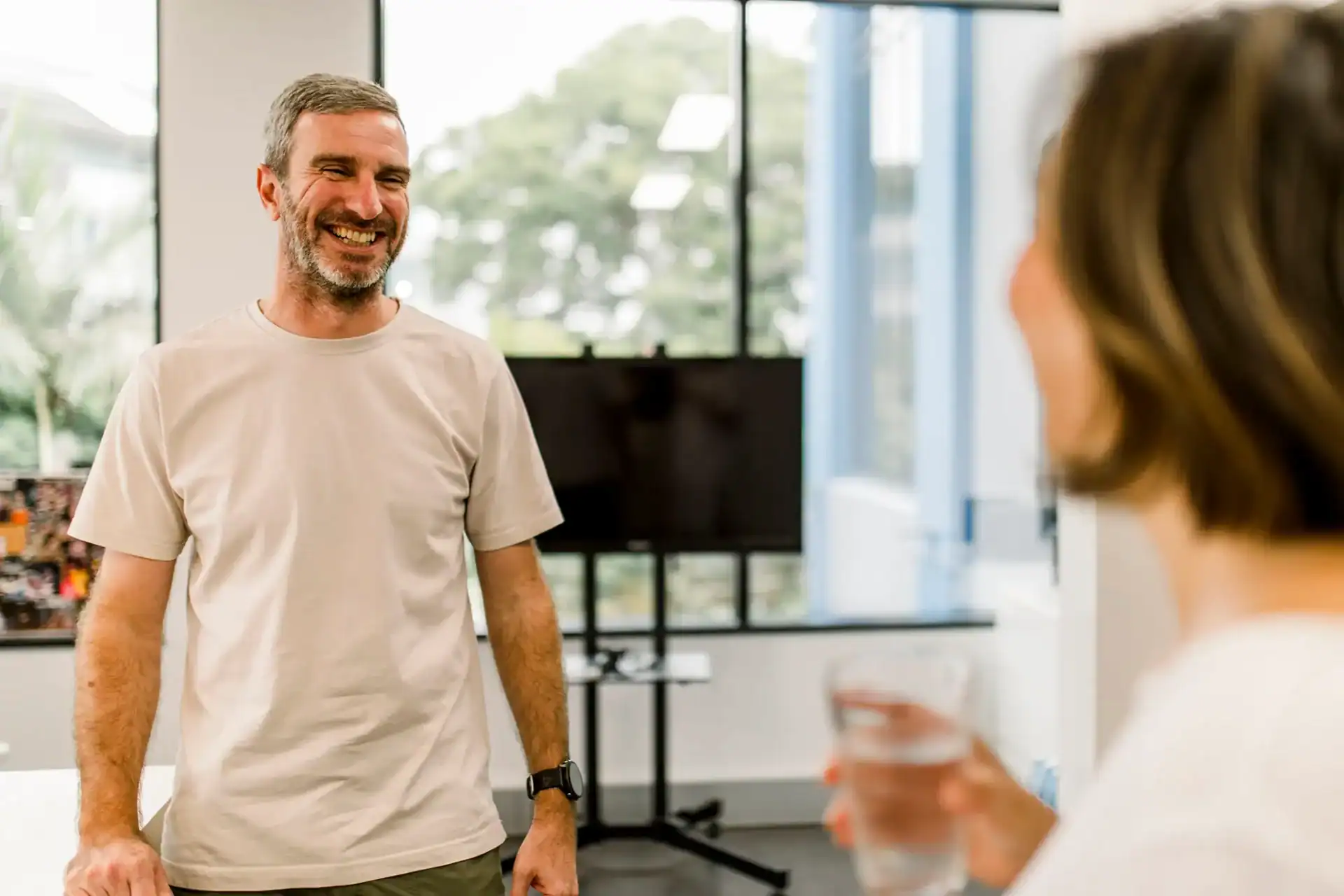 Shane chatting with a colleague at the Excite Media office