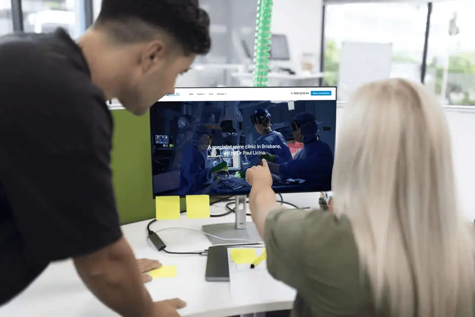 two people collaborating while viewing a medical website